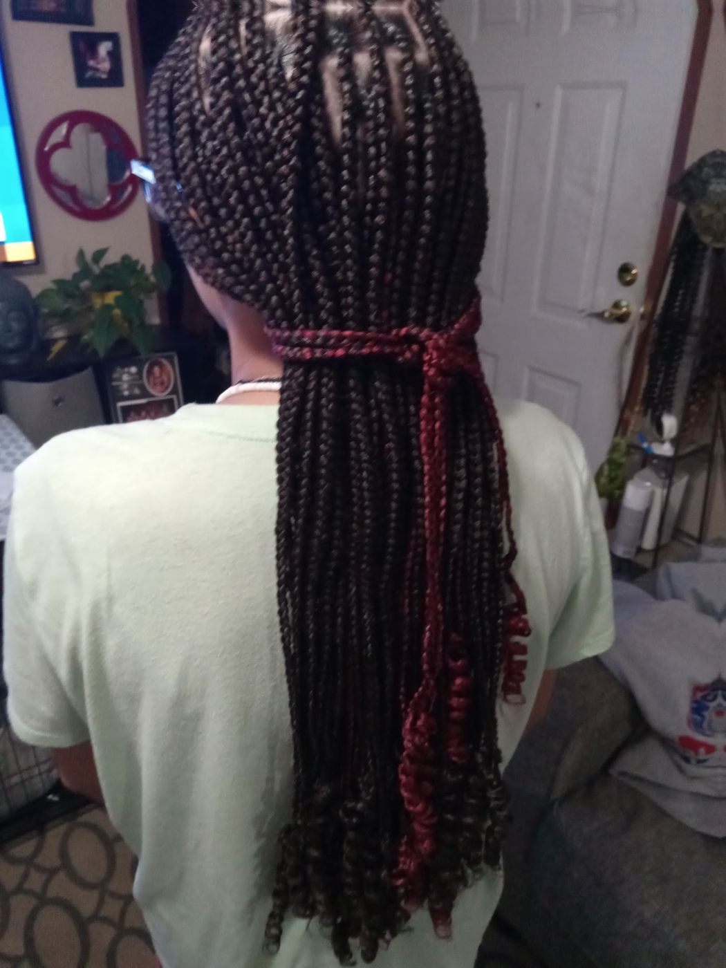 Knotless braids tied back with burgundy peek-a-boo